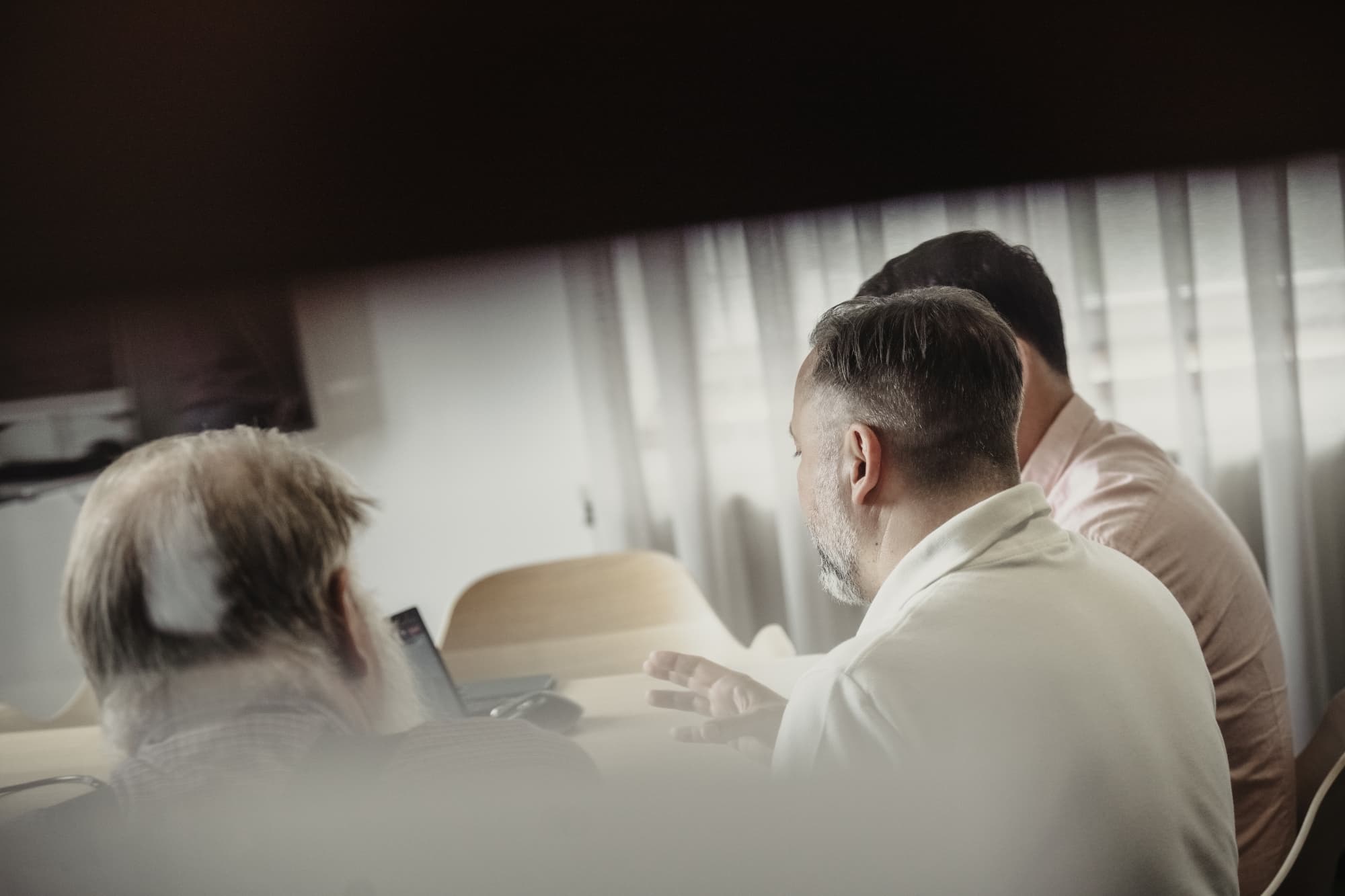 Professionals working on laptops, asset management team, financial data workflow
